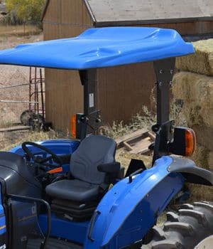 Blue New Holland tractor with a blue fiberglass canopy